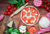 Пицца в процессе производства, крупный план — стоковое фото