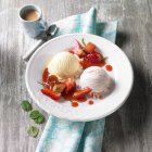 Vanilla, and lemon-and-strawberry ice cream with strawberry and rhubarb compote — Stock Photo