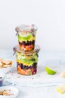 Layered Mexican salads in jars — Stock Photo
