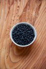 A bowl of dried black beans — Stock Photo