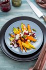 Colourful roasted carrots with pesto and feta cheese — Stock Photo