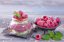 Acai chia pudding with frozen raspberries and mint leaves — Stock Photo