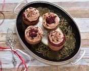 Vegan chestnut and chocolate cherry cakes on a vintage platter — Stock Photo