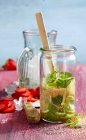 Punch with strawberries, limes, mint and brown sugar being made — Stock Photo