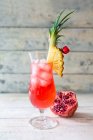 Singapore Sling in cocktail glass garnished with pineapple — Stock Photo