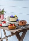 Chocolate cake, cheesecake with berries, whitechococolate blueberry cake and strawberry pavlova — Stock Photo