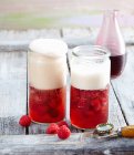 Wheat beer punch with raspberry syrup and raspberries — Stock Photo