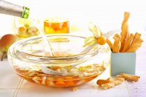 Pear punch with physalis served with savoury snacks — Stock Photo