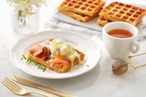 Waffle with Smoked salmon, opened poached egg and sauce — Stock Photo