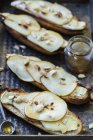 Toasts with camembert cheese, pears, walnuts and honey — Stock Photo