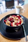 Yoghurt muesli with almonds slices and plums — Stock Photo