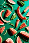 Slices of fresh watermelon, whole, eaten and peels on green background — Stock Photo