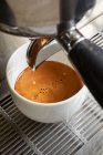 Close-up shot of Creamy coffee from a coffee maker — Stock Photo