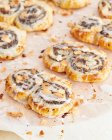 Poppy seed puff pastry buns with icing and flaked almonds — Fotografia de Stock
