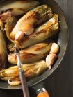 Roasted chicory with garlic — Stock Photo