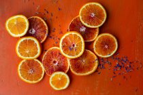 Blutorangen, Orangen und essbare Blütenblätter — Stockfoto
