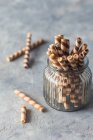 Close-up shot of delicious Wafer roll cookies in a jar — Stock Photo