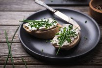 Spelt baguette with almond cream cheese and chives — Stock Photo