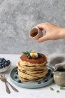 Pancakes with blueberries, butter, maple syrup and mint — Stock Photo