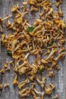 Fresh chanterelles with parsley on wooden board — Stock Photo