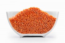 Orange lentils in a cross-cut bowl — Stock Photo