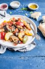 French Ratatouille made with bell peppers, eggplant, yellow courgette, onion and garlic, served with fougasse — Stock Photo
