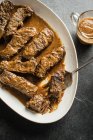 Mustard beer braised short ribs in plate with fork — Stock Photo