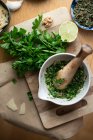 Pesto verde with parsley and mint being made in a mortar — Stock Photo