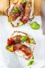 Bread topped with avocado, bacon and basil — Stock Photo
