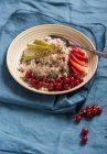 Millet cooked in coconut milk with fresh fruit and grated chocolate (vegan) — Stock Photo