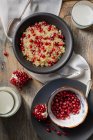 Homemade cranberry pudding with pomegranate seeds and cranberries on a wooden background. top view. — Stock Photo