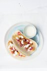 Filetes de peixe batidos de cerveja em tortilhas de trigo com couve fresca e salada de cenoura, anéis de cebola vermelha em conserva e nata azeda — Fotografia de Stock