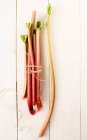 Fresh red asparagus in wooden basket, on a light background, top view, selective focus, copy space — Stock Photo