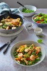 Colorful pasta with shrimps and green peas — Stock Photo