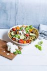 Pasta salad with peas, zucchini, minced meat and feta — Stock Photo
