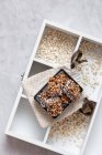Buckwheat crispbread or puffed buckwheat with chocolate on wooden vintage textural box — Stock Photo