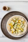 Turkish pide with green and yellow baby zucchini, feta and chilli flakes — Stock Photo