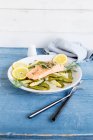 Braised salmon fillet on spring vegetables — Stock Photo