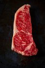 Sirloin Steak top view on black background — Stock Photo