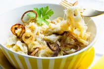 Cheese spaetzle (home-made noodles) with fried onions — Stock Photo