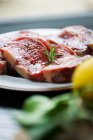 Raw beef steaks with rosemary — Stock Photo