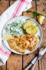 Paniertes Fischfilet mit Kartoffeln und Gurkensalat — Stockfoto