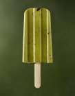 Cashew matcha on a stick against a green background — Stock Photo