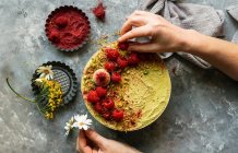 Vegan raw cashew cake with berries, coconut butter and coconut milk, and base made of almonds, dates — Stock Photo