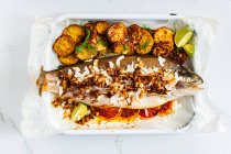 Citrus Stuffed Rainbow Trout with Coconut and Shallot Topping — Stock Photo