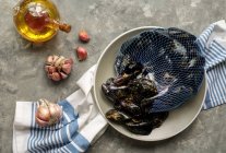Fresh raw sea mussels with garlic ready to be cooked — Stock Photo