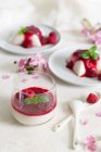 Vegan panna cotta with raspberries mousse in glass and on plates — Stock Photo