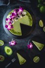 Avocado and lime cheesecake decorated with flowers and pistachios — Stock Photo