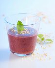 Blueberry and hazelnut smoothie with apple and orange in a glass with lemon balm — Stock Photo