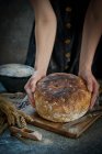 Close-up shot of delicious Woman hold sourdouh bread — Stock Photo